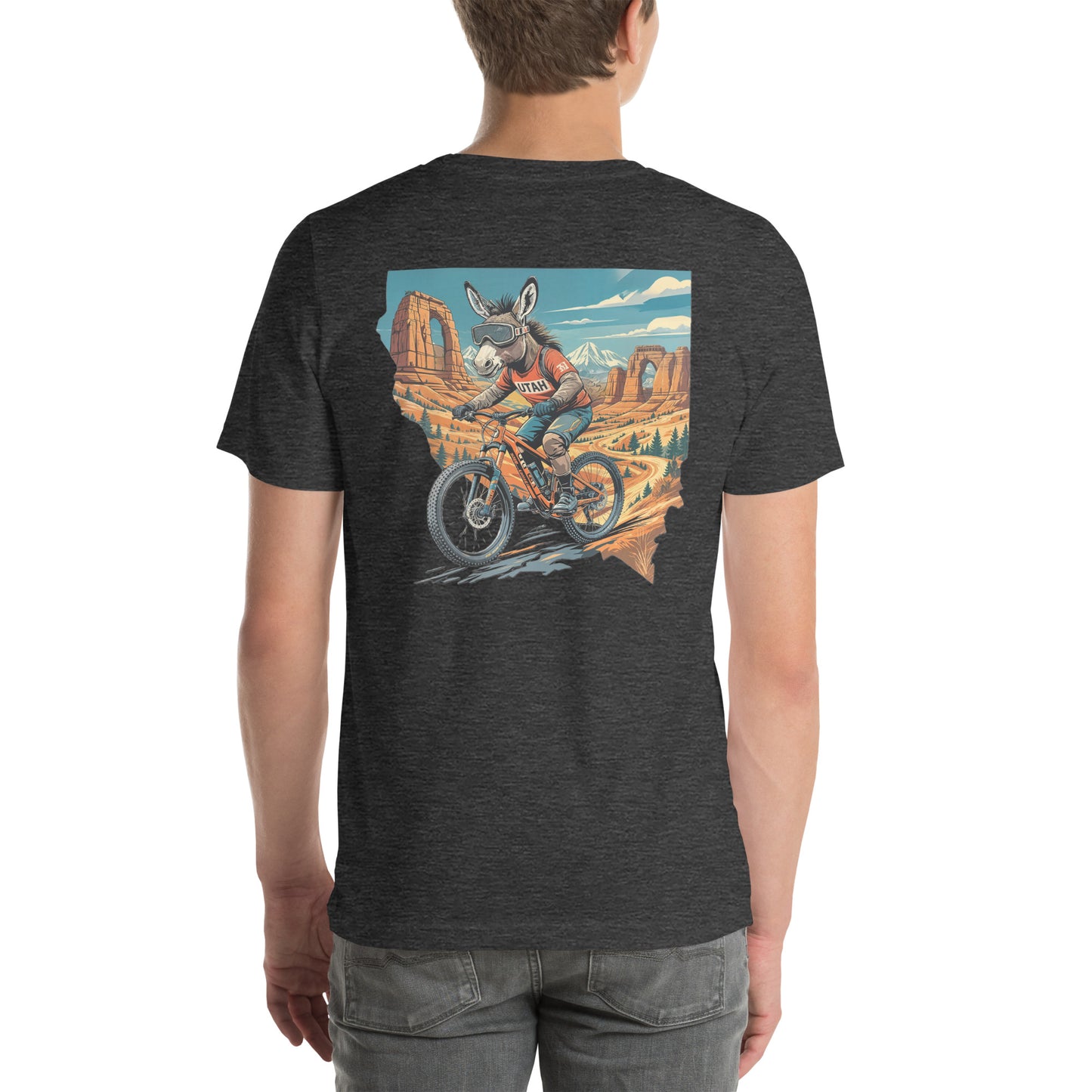 Person wearing a dark gray t-shirt with a graphic of a donkey on a motorcycle in a desert landscape.