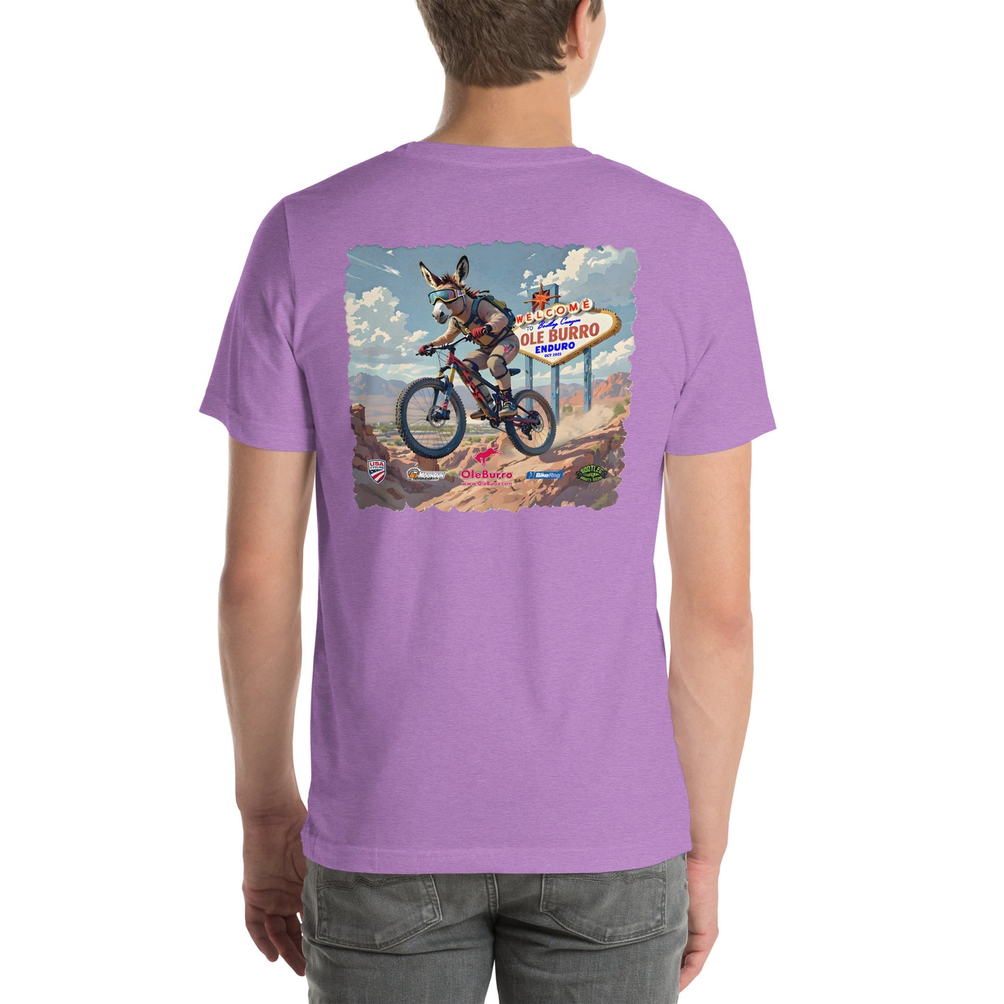 Person wearing a purple t-shirt with a graphic of a donkey on a bike and a sign in the background.