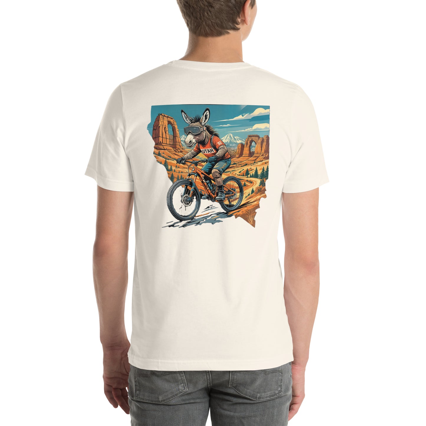 Person wearing a t-shirt with a graphic of a donkey riding a bike in a desert landscape.