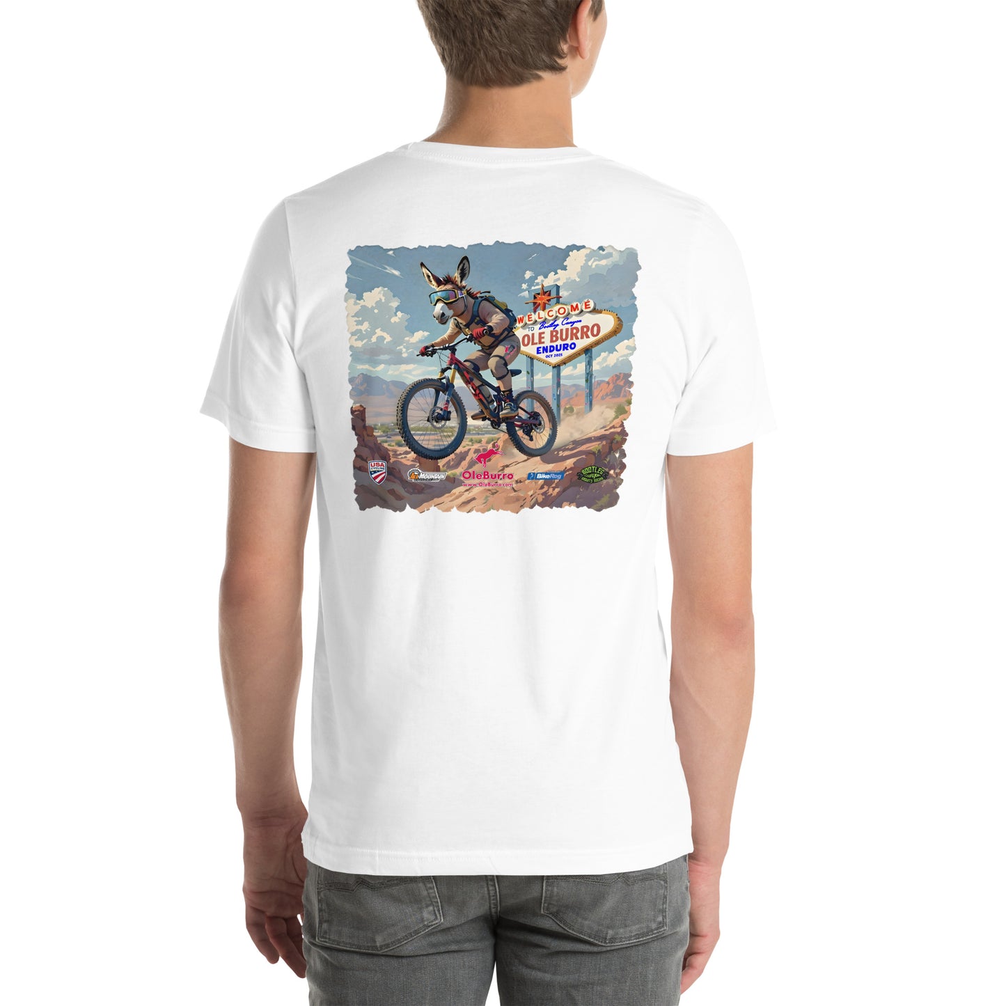 White t-shirt with a graphic of a donkey riding a bike and a sign on the back, worn by a person.